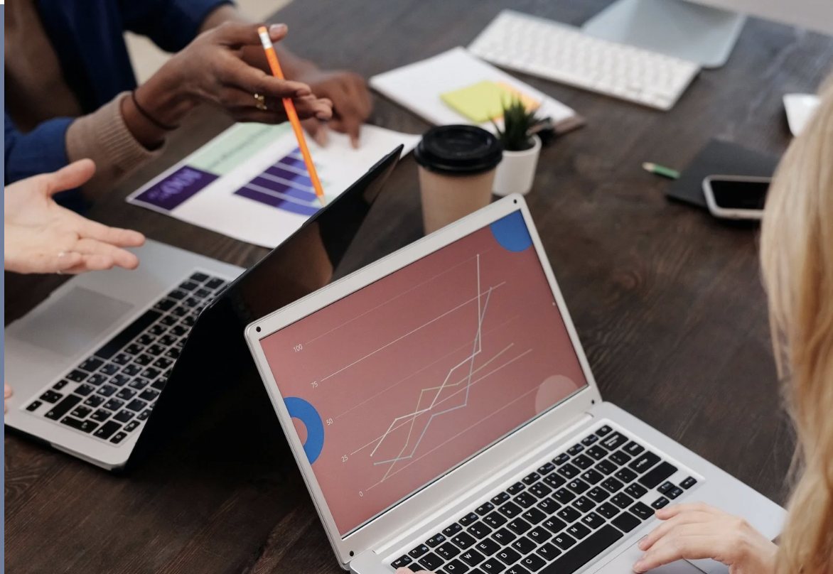Business owners reviewing revenue charts on laptops during a working session