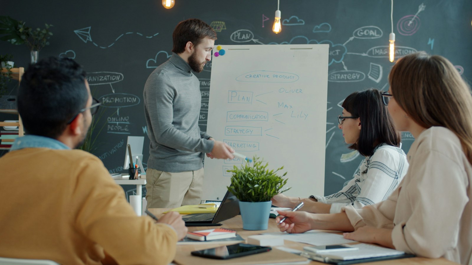 A team planning together at a whiteboard in a modern office
